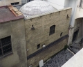 -External view of the facade overlooking the courtyard of the Curia and the dome of the Baptistery   
